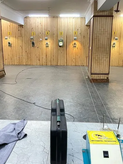 A wide shot of our shooting lanes at the Punjabi Bagh Club, showing the setup with target pulleys and shooting stations.