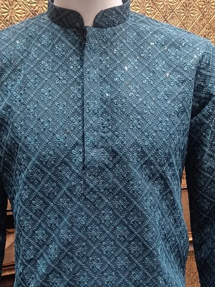 A teal green kurta with all-over tonal embroidery and subtle sequin details. This is a rich and elegant choice for a sangeet or mehndi night.