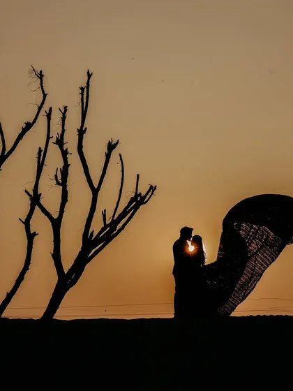 A silhouette against a golden sunset is a timeless way to capture romance. I specialize in finding the perfect light and location to create these artistic and emotional pre-wedding shots that feel both intimate and grand.
