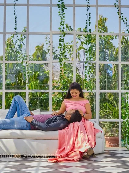 Our glasshouse set, filled with greenery, provides beautiful natural light for a relaxed and romantic couple's portrait.