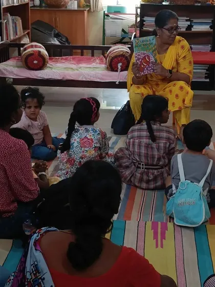 Children and parents sit together, listening to a story about protecting oneself from danger. We choose stories with important life lessons presented in an age appropriate way.