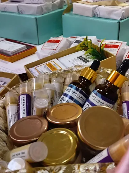 A basket of goodies at my corporate gig with Sony Pictures, featuring hair oils, body butters, and lip balms.
