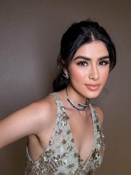 A close-up of a soft glam look perfect for a cocktail party. The makeup features a gentle smokey eye, luminous skin, and a glossy nude lip for a sophisticated and polished finish.