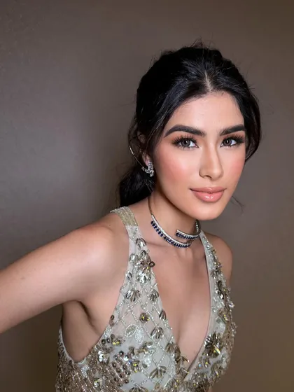 A close-up of a soft glam look perfect for a cocktail party. The makeup features a gentle smokey eye, luminous skin, and a glossy nude lip for a sophisticated and polished finish.