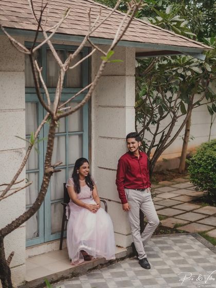 A relaxed portrait of the couple outside their resort cottage, using the architecture to frame the shot beautifully.