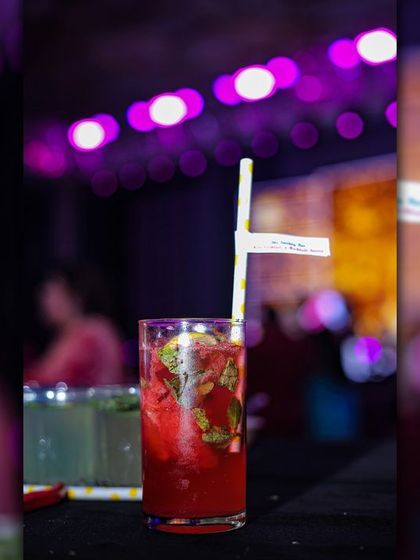 A vibrant red watermelon mojito. This drink is a visual delight and a crowd-pleaser, especially at outdoor events and festive gatherings like Holi parties.