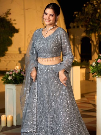 A happy and smiling shot in the grey sequin lehenga, showing how it catches the light beautifully. It's a perfect party-ready outfit.