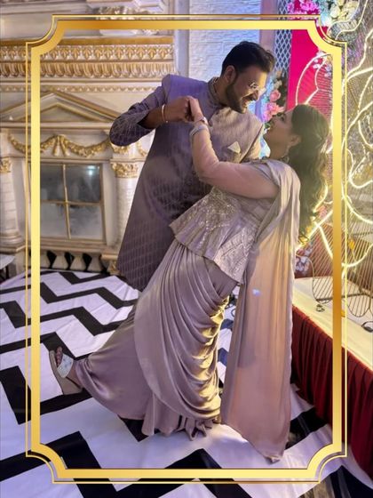 This couple is dancing the night away in their stylish rental outfits. Her peplum saree gown perfectly matches his indo-western suit.