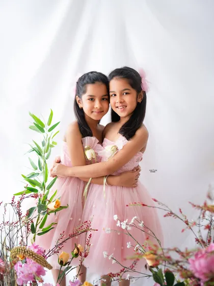 Double the giggles, double the love! Capturing the special bond between siblings, especially twins, is such a joy. This 7th birthday photoshoot was all about their sweet connection, with soft pink dresses and a clean, bright backdrop to let their personalities shine.