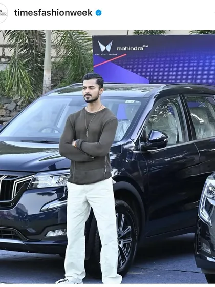 Another shot from the Mahindra promotional campaign, showcasing the car's sleek design and my complementary fashion look.