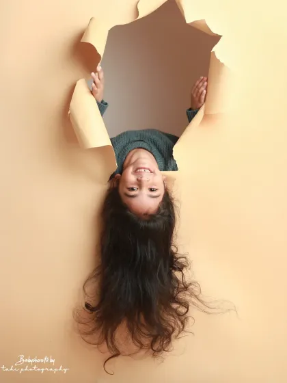 A different perspective! An upside-down pose adds a fun, whimsical twist to our creative paper-tear shoot.
