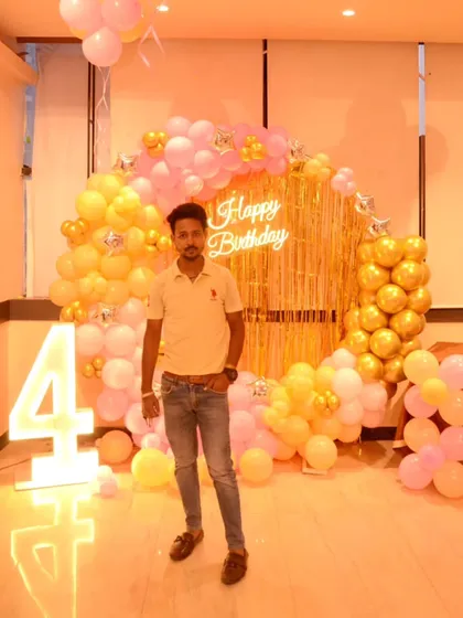 A full view of the 4th birthday ring decoration with a golden fringe curtain and a marquee number '4'.