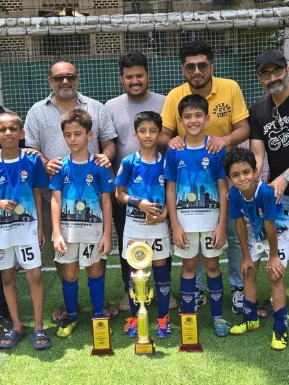 Our U-9 champions with their proud parents and coaches, celebrating a tournament victory together.