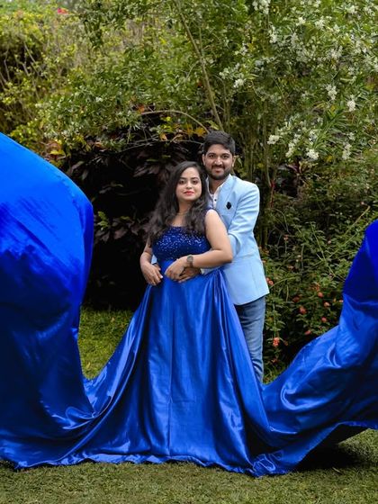 A beautiful shot of a flowing blue gown in our garden, with the fabric creating a stunning wave-like effect.