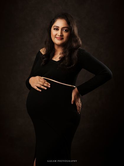 A classic, confident pose. This portrait is all about celebrating the strength and beauty of the female form during pregnancy.