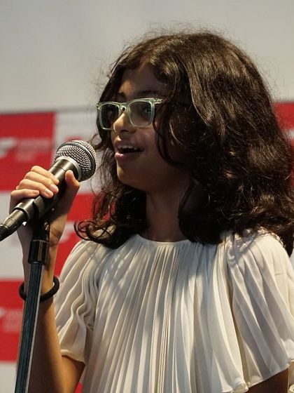 A young singer performs with passion at our Chembur center event. Our vocal coaching focuses on technique, expression, and stage presence to help students connect with their audience.