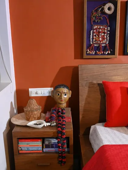 A bedside detail from the makeover, featuring a framed piece of Mochi Bharat embroidery and other collected objects. It's all about creating a home that reflects your personal story.