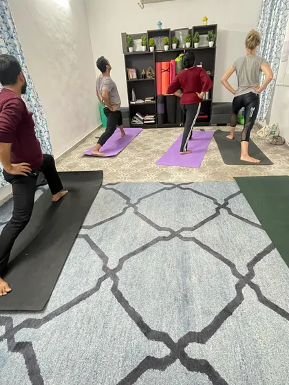 A snapshot from one of my group classes in Delhi. I guide a small batch of students through Virabhadrasana I, or Warrior I pose. I focus on correct alignment for each person to ensure they build strength safely and effectively.