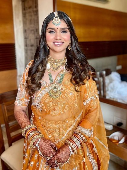 A happy bride, ready for her Pheras. The makeup is kept fresh and radiant to let her natural beauty shine.