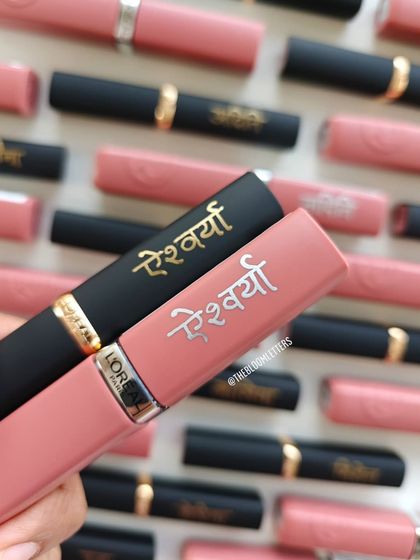 A close up of the L'Oréal lipsticks I personalized for 'Aishwarya'. The elegant Devanagari script adds a unique and personal touch to these beauty essentials.