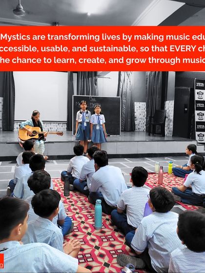 Two young girls stand confidently on a small stage, singing for their peers. This is a powerful example of how we transform lives by making music education accessible, giving every child the chance to grow.