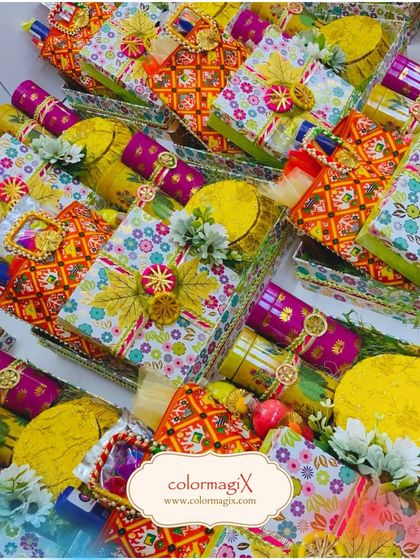 A sea of colorful Holi hampers ready for celebration. These trays are filled with traditional sweets and festive decorations, perfect for large-scale gifting.
