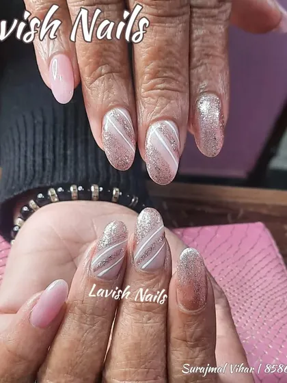 A lovely mix of full glitter nails and glitter nails with a white swirl pattern.