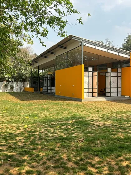 A wide shot of our center, showing the modern architecture, large glass windows for natural light, and the spacious, well-maintained lawn.