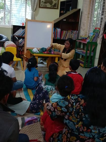 A storyteller uses props to tell the story of the Three Little Pigs, making the classic tale fresh and engaging.