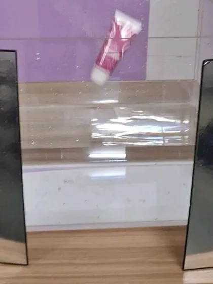 The setup for our underwater splash shot, showing the water tank, mirrors for lighting, and the product ready to be dropped.