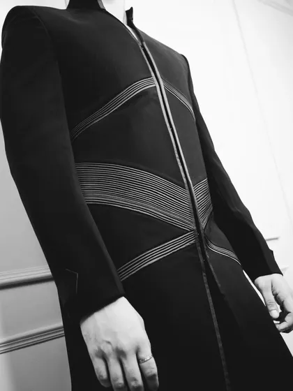 The 'Grooved Lines' jacket in a dramatic black and white shot, emphasizing the texture, lines, and modern cut of the design.