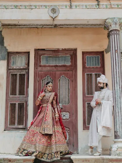 A grand, full-length portrait of the couple against a heritage backdrop, looking every bit like royalty.
