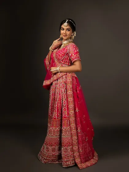 A full-length profile shot of the bridal lehenga, showing its beautiful flare and intricate details.