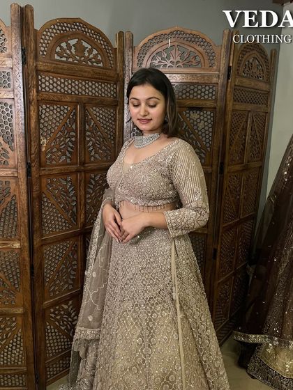 This full-sleeve beige lehenga is the definition of elegance. The intricate silver embroidery gives it a rich, textured look, perfect for a modern bride or bridesmaid.