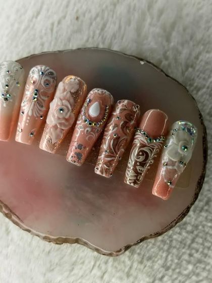 These are custom press-on nails designed for a bride. The intricate 3D floral and baroque patterns, accented with crystals, offer a regal and highly detailed look that can be applied anytime.