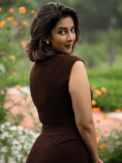 An outdoor portrait of a model in a chic brown dress, showcasing our ability to use natural light and environments to create compelling fashion images that feel both elegant and authentic.