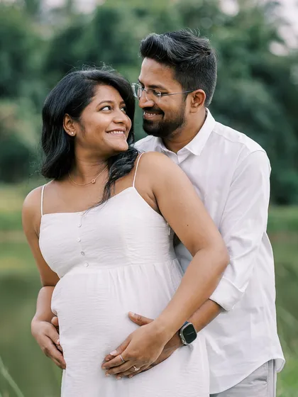 A lovely portrait of the couple by the water. Their happy expressions and easy embrace show the joy they share as they look forward to meeting their baby.