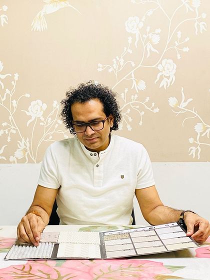 A photo of me selecting clay cladding samples, a durable and eco-friendly option for exteriors.