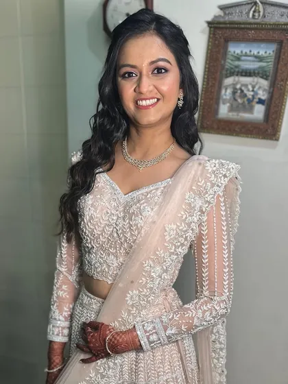 Barely-there blush and endless allure. This dreamy look in a soft peach lehenga is perfect for an engagement party.