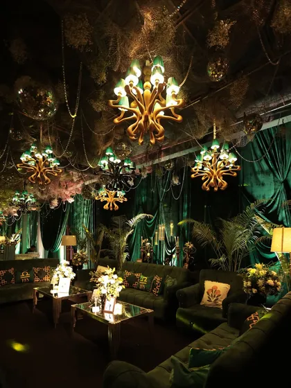 Design can be playful and unexpected. We brought the outdoors in for this 'Jungle Disco' sangeet, filling a ballroom with lush green velvet, a ceiling of cascading foliage, and custom chandeliers to create a glamorous, moody, and unforgettable party atmosphere.