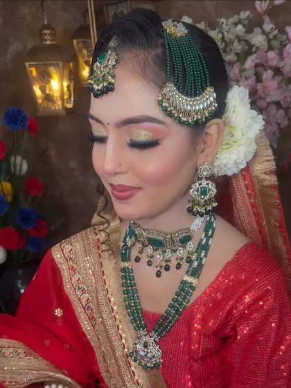 This shot focuses on the eye makeup and the detailed jewellery. The combination of gold, green beads, and pearls makes this set a timeless choice for any bride.