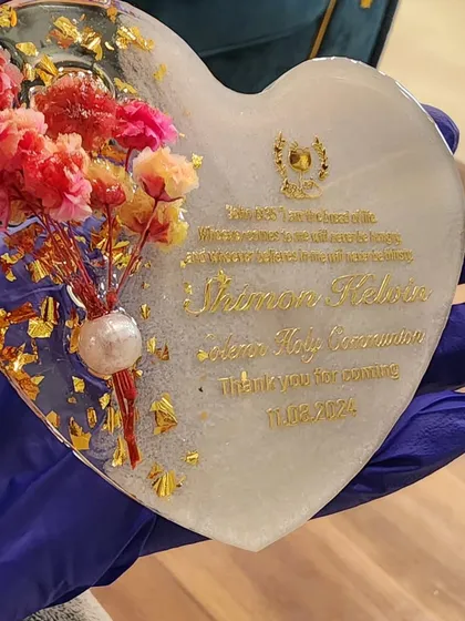 Holding a completed heart-shaped magnet for Shimon Kelvin's Holy Communion. I wish my client everlasting happiness, peace, and joy.