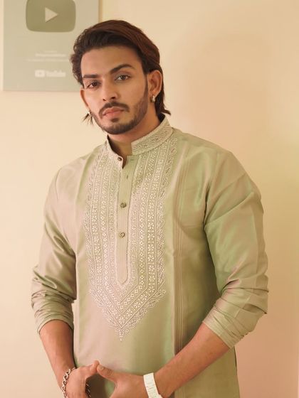 A closer look at the sage green kurta worn by Shadab Khan. The detailed embroidery is clearly visible, showcasing the quality of my craftsmanship.