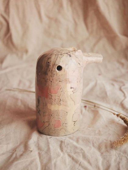 This singing pajarito is made with the Nerikomi technique, giving it a beautiful, marbled plumage with soft pink patches. The shape of each whistle changes its sound.