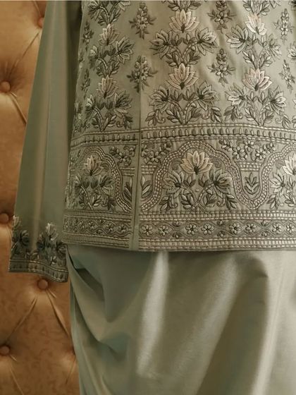 A closer look at the delicate Resham and Zari work that adorns the jacket, showcasing our commitment to fine craftsmanship.