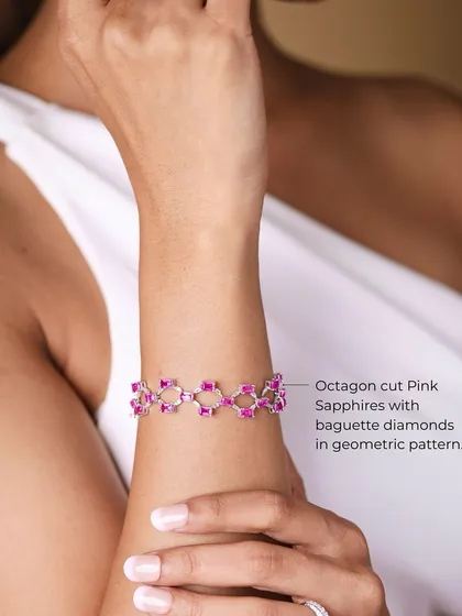 A close-up of the Pink Geometry bracelet on the wrist, detailing its geometric pattern of pink sapphires and diamonds.