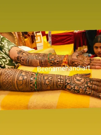 A beautiful bridal mehandi extending up to the elbows, with a mix of traditional motifs like elephants and peacocks.