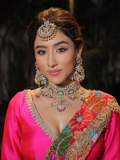 A close-up on this vibrant and fresh makeup look. The bright pink lip and softly defined eyes are a perfect match for the colourful outfit.