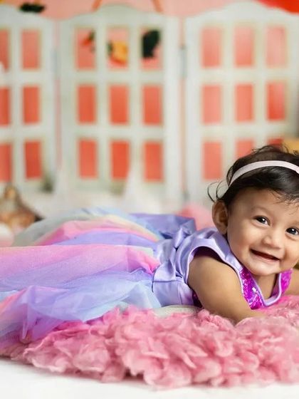 This happy baby's smile can make anyone's day. We love capturing these joyful expressions on our colorful, themed sets.