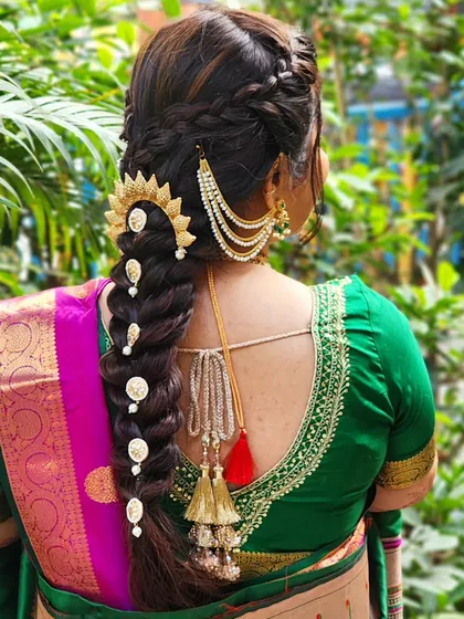 An intricate hairstyle can elevate the entire bridal look. My talented hair team created this stunning, detailed braid, accessorized with traditional gold pieces, which perfectly complements a classic Maharashtrian bridal saree. We design hairstyles that are both beautiful and secure.